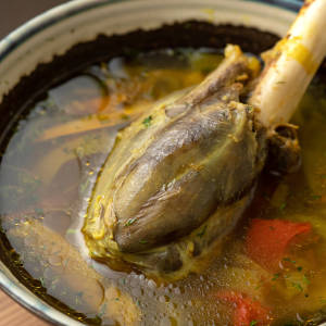 Slow cooked lamb shank, mellowing in a vegetable broth.